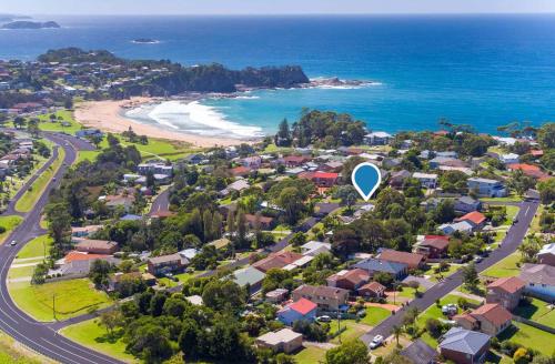 an aerial view of a suburb with a blue circle in the sky at Classic Meets Contemporary 1960's Beach House in Malua Bay