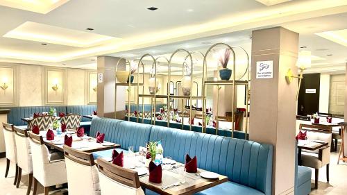 a dining room with tables and chairs in a restaurant at JK Clarks Exotica in Dalhousie