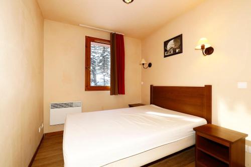 En eller flere senge i et værelse på Albane Vars 2-Room Apartment