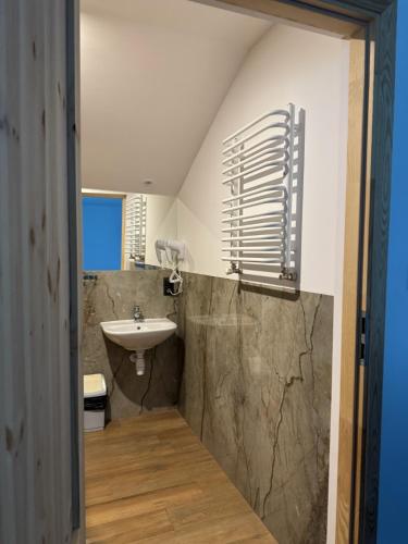 a bathroom with a sink and a toilet and a mirror at Zajazd Pod Gwiazdami in Lublin