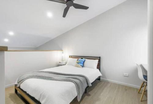 a bedroom with a bed with a ceiling fan at Cozy Sunnybank Base - Unit 3 | Near Shops & Eats in Brisbane