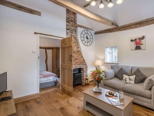 een woonkamer met een bank en een open haard bij 1 Bed in Finningham 85401 in Finningham