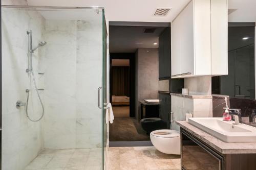 a bathroom with a shower and a sink and a toilet at The Platinum Kuala Lumpur by MAHA in Kuala Lumpur