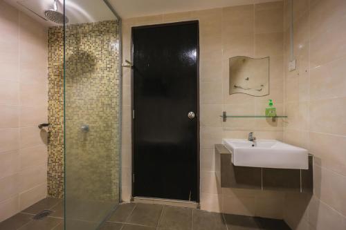a bathroom with a sink and a shower and a sink at Marina Island Lumut 3 Bedroom Holiday Apartment in Lumut
