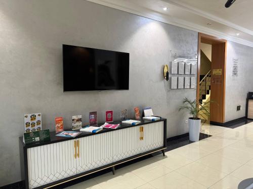 een kamer met een televisie aan een muur en een aanrecht bij Moon hotel in Yakkasaray