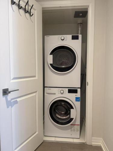 a washer and dryer in a small room with a door at Cozy holiday home in Toronto