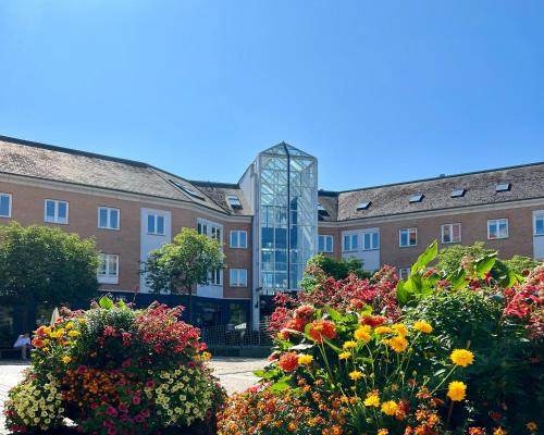 a group of flowers in front of a building at Mortens Kro Boutique Hotel in Aalborg