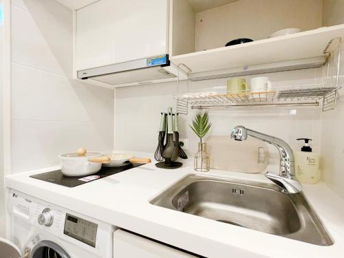 a kitchen with a sink and a dishwasher at 엠지스테이 서면 Mzstay Modern Hotel in Seomyeon in Busan