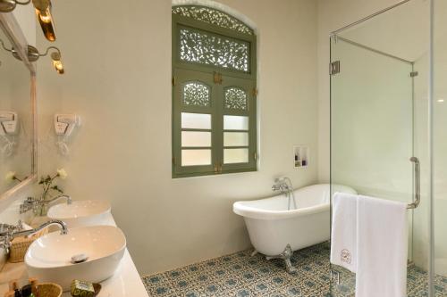 a bathroom with a tub and a sink and a bath tub at Ridee Kandy in Kandy