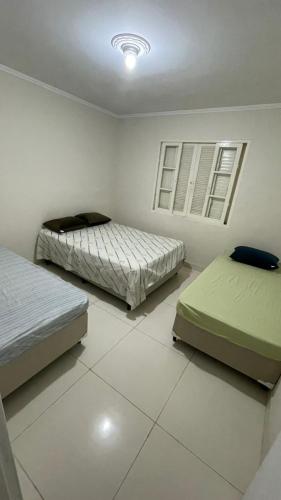 Кровать или кровати в номере Chácara da Sol 10 pessoas