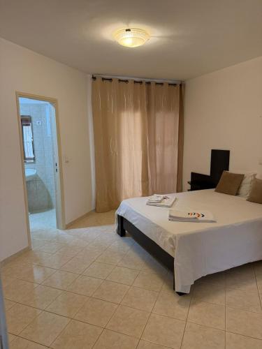 a bedroom with a bed and a chair in it at Murdeira V162 A in Beirona