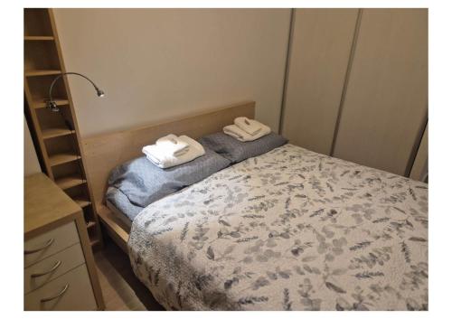 a bedroom with a bed with two towels on it at Apartament przy szpitalu CZMP Łódź in Łódź