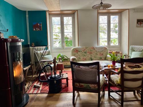 a living room with a couch and a table at Le verger d'Aglaé&Michel in Verdun