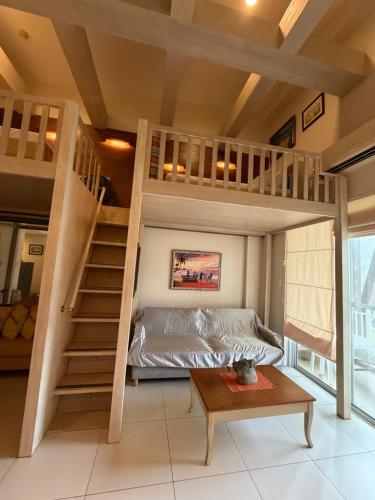 a room with a bunk bed and a staircase at Pico de loro in Nasugbu