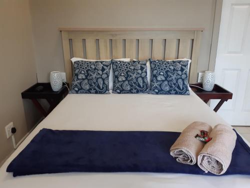 a bedroom with a bed with towels on it at THE VIEW in Port Alfred