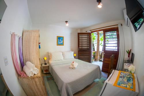 Postel nebo postele na pokoji v ubytování Pipa Surf Yoga Apartamento e Suítes com cozinha completa