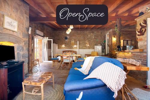 a living room with a blue couch and a table at Monte Viana in Fuzeta