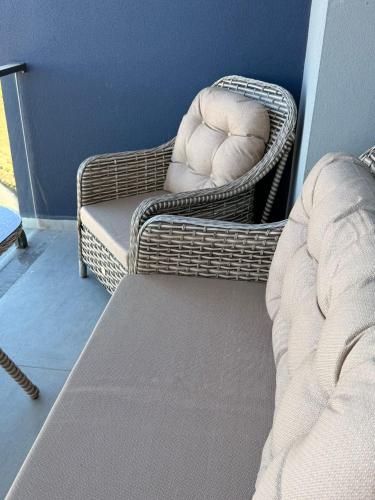 a bedroom with a bed and a chair and a couch at Studıo Iskele 150 in Aglantzia