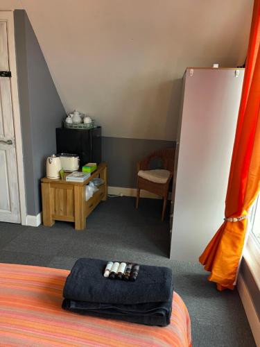 a room with a bed with two remote controls on it at Reggae Beach Getaway in Saltdean