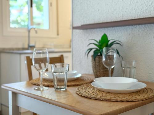 a table with plates and glasses on a table at DOMuum Holidays - DELFOS in Salou