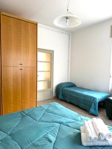 a bedroom with two beds and a closet at Suite Barni in Barni
