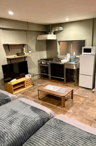 a room with a kitchen and a living room at oak HOUSE in Matsuyama