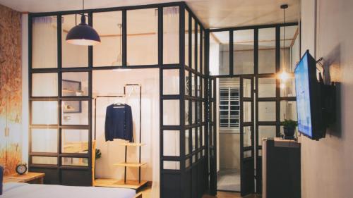 a room with a large glass window with a bed at Indiego Space in Loei