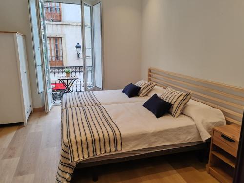 a large bed in a room with a large window at alojamiento premium Ribadesella 2 dorm in Ribadesella