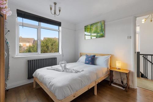 a bedroom with a bed with a swan on it at Exeter Heights - Short Stays UK Ltd in Exeter