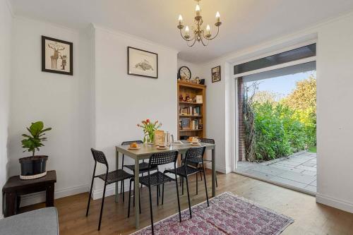 a dining room with a table and chairs and a window at Exeter Heights - Short Stays UK Ltd in Exeter
