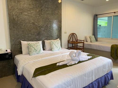 Кровать или кровати в номере Suntalee House