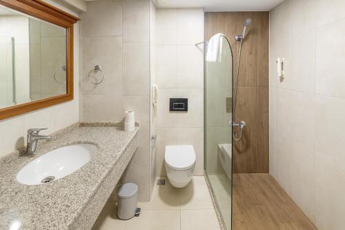 a bathroom with a sink and a toilet and a shower at Kayhanbey Hotel in Kusadası