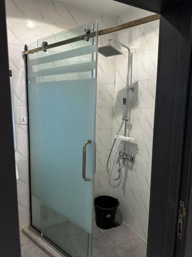 a shower with a glass door in a bathroom at Modern 3-Bedroom Luxury Home in Lekki Phase 1 in Lekki