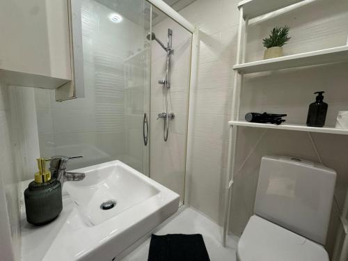 a bathroom with a sink and a shower and a toilet at I&A Residence - Roseni tn in Tallinn