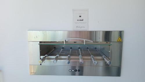 a stove with tongs on top of it at Refugio de lujo Piscina con Vistas panorámicas in Encarnación