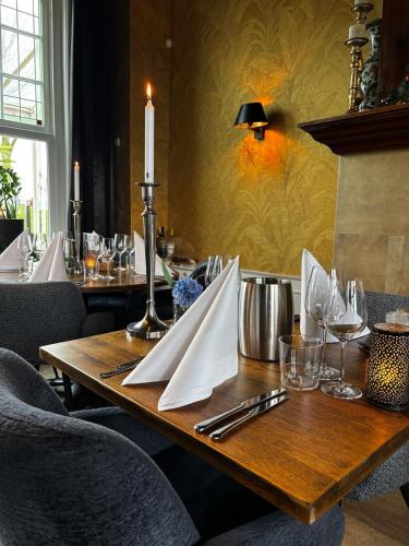 a table in a restaurant with a candle on it at De Gouden Molen in Rossum