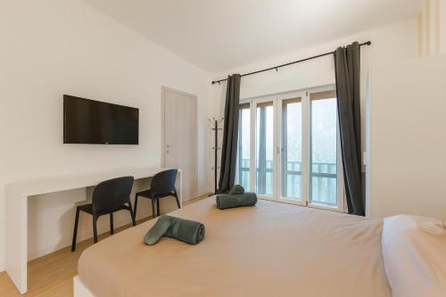 En eller flere senge i et værelse på Moderna stanza 2 con terrazza vicino alla Stazione