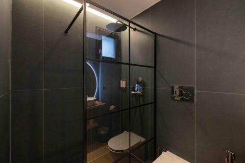 a bathroom with a glass shower with a toilet at Gran Suite Darsena in Isola Sacra