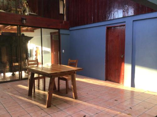 a wooden table in a room with a door at Jodokus Inn in Montezuma