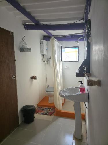 a bathroom with a sink and a toilet at La Farola del Cabo in Cabo Polonio