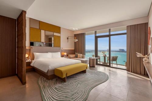 a bedroom with a bed and a view of the ocean at SO Ras Al Khaimah Hotel & Resort-Ultra All Inclusive in Ras al Khaimah