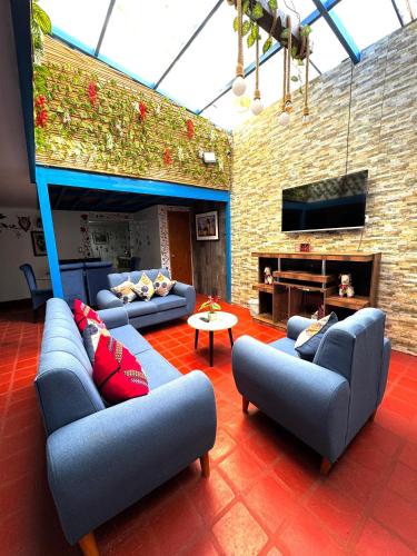 a large living room with couches and a fireplace at AITANA'S HOUSE - SAN BLAs in Cusco