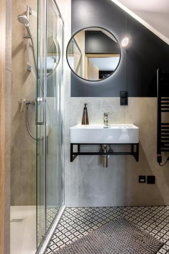 a bathroom with a sink and a mirror at Apartamenty RIO Oława in Oława