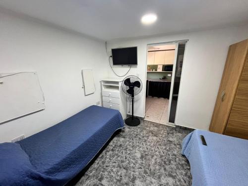 Luz de mar في سانتا كلارا ديل مار: غرفة نوم بسرير وغرفة بها مروحة