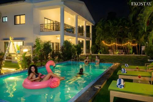 a group of people in a swimming pool at a house at Ekostay Luxe - CASA SIA - Ideal for Big Groups- Poker Table in Lonavala
