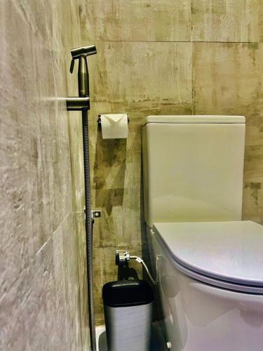 a bathroom with a toilet and a roll of toilet paper at Villa Mangrove Serenity in Galle