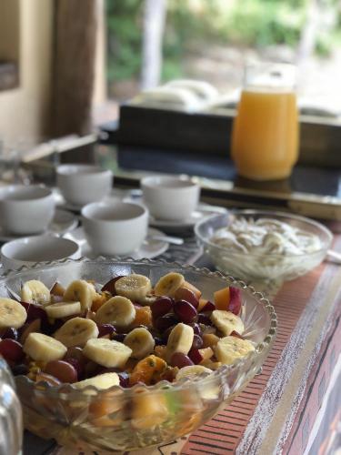 a table with a glass plate of fruit and nuts at Muweti Bush Lodge in Grietjie Nature Reserve