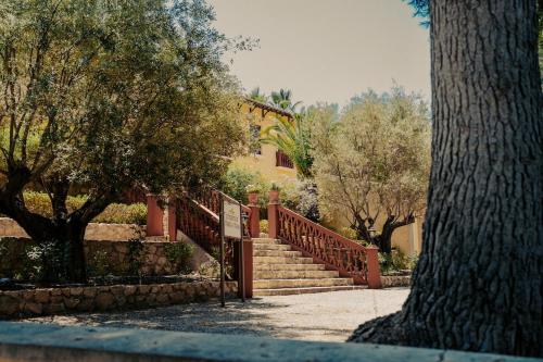a set of stairs in front of a house with trees at Casa Rural 5 Estrellas en Totana in Totana