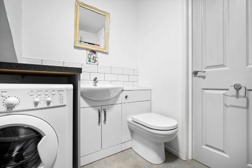 a white bathroom with a toilet and a sink at 4 Bedroom Town House Perfect for families or contractors Sleeps 8 in Halesowen