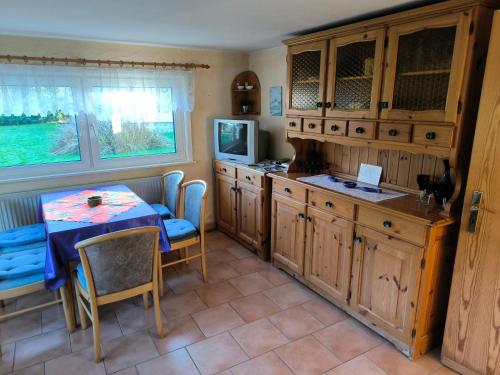 a kitchen with a table and a dining room at Schwanensee Ferienhaus in Göhren